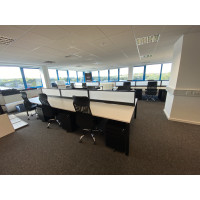 Elva mesh chair with Adapt bench desks with desk screens and black steel pedestals